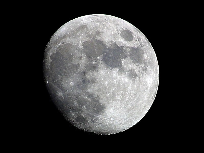 Full moon photographed against a dark sky (Artemis lunar-path context)