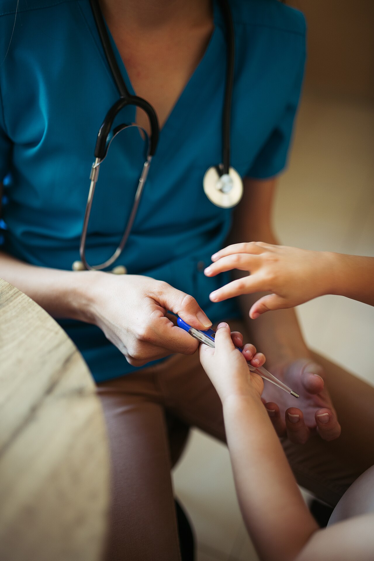 Pediatrician with parent and child in clinic