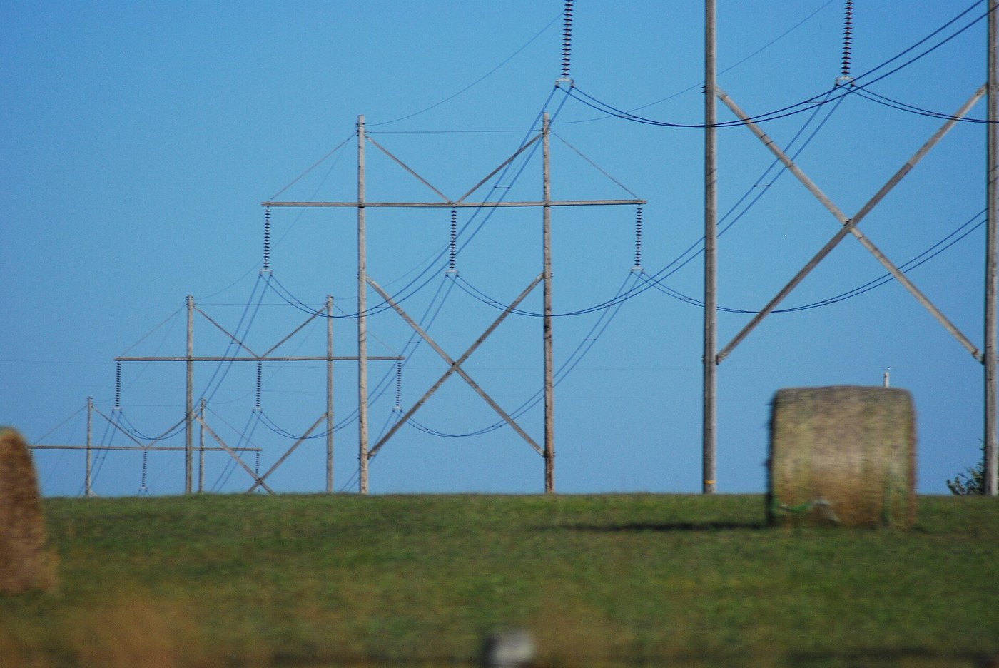 High-voltage power lines against a blue sky