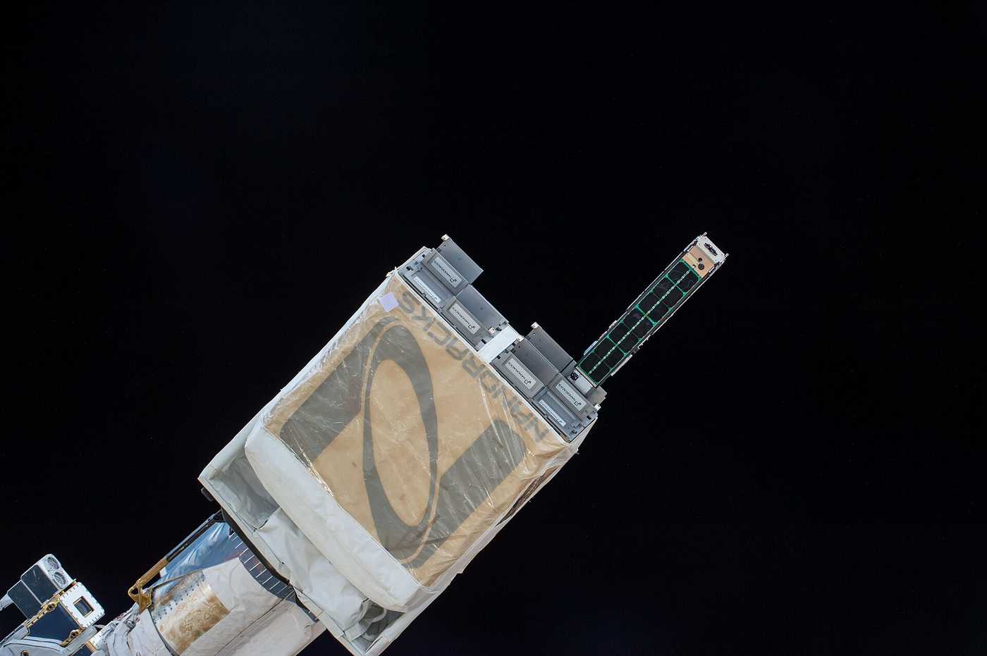 CubeSat leaving a NanoRacks deployer in orbit