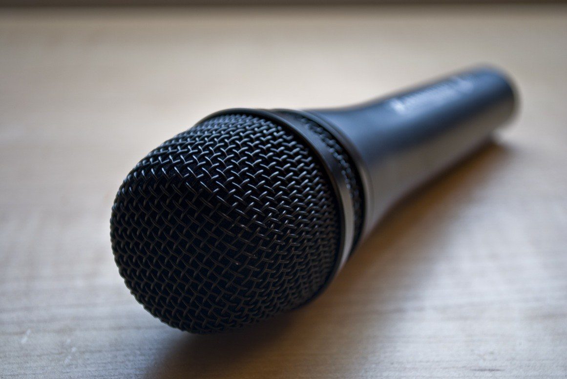 Podcast microphone and headphones on a home desk