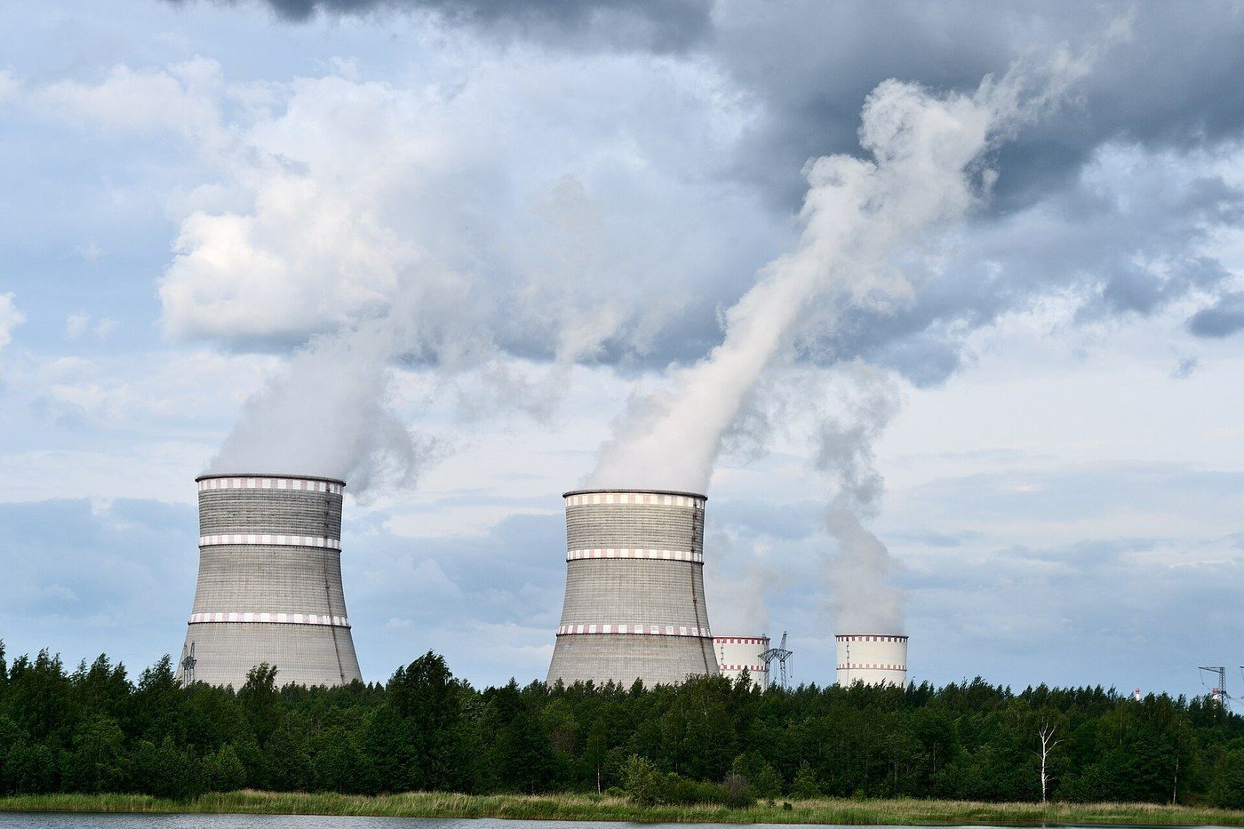 Nuclear power plant cooling towers beside a river