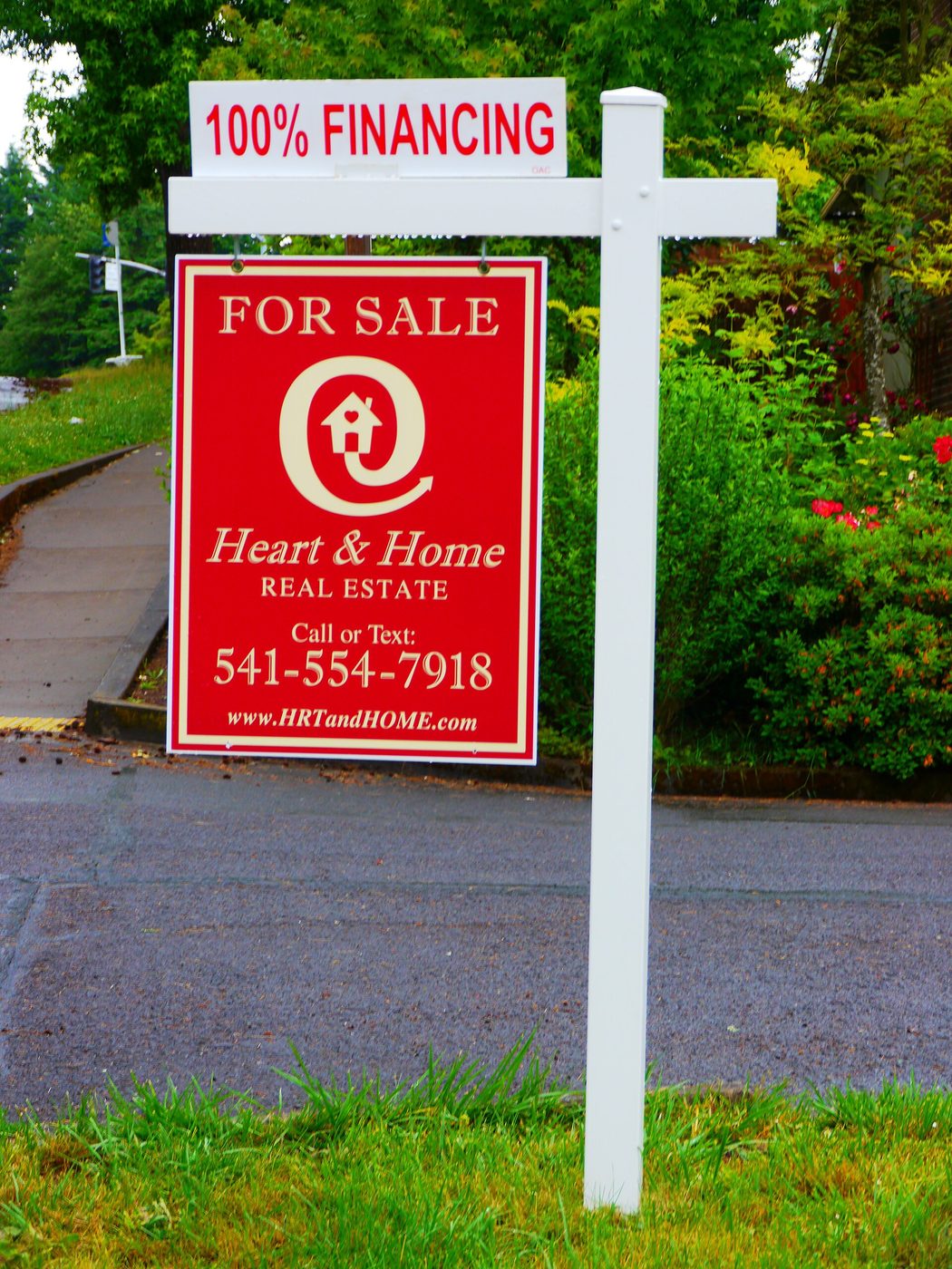 A real estate for-sale sign in front of a house in Eugene, Oregon