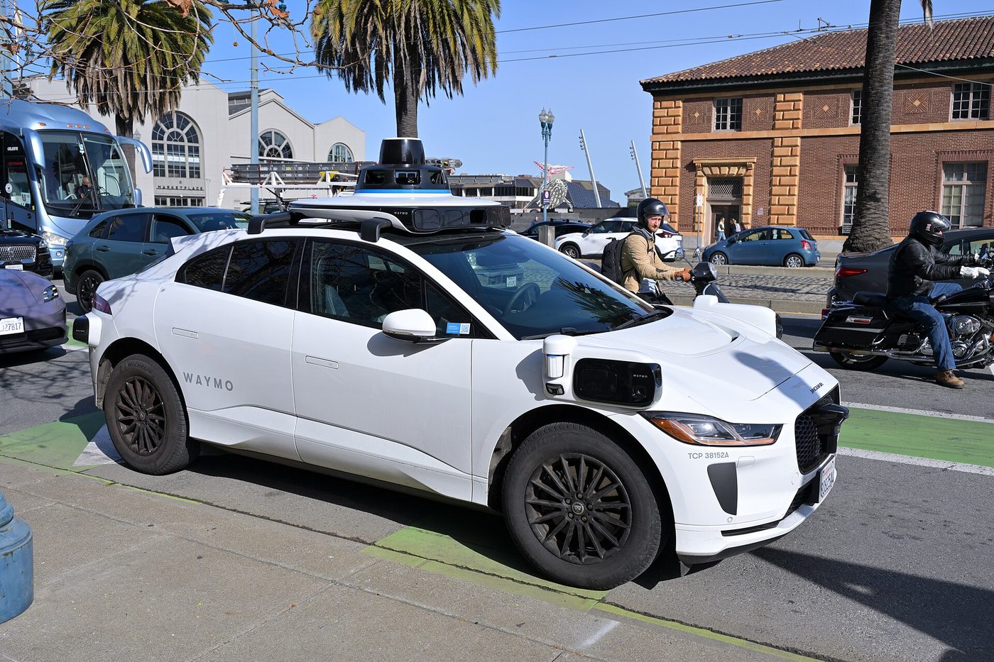 A Waymo Jaguar I-Pace robotaxi on the Embarcadero in San Francisco