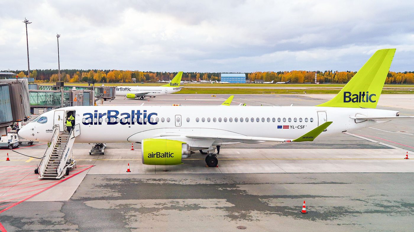 An airBaltic Airbus A220-300 at the gate at Riga Airport in Latvia