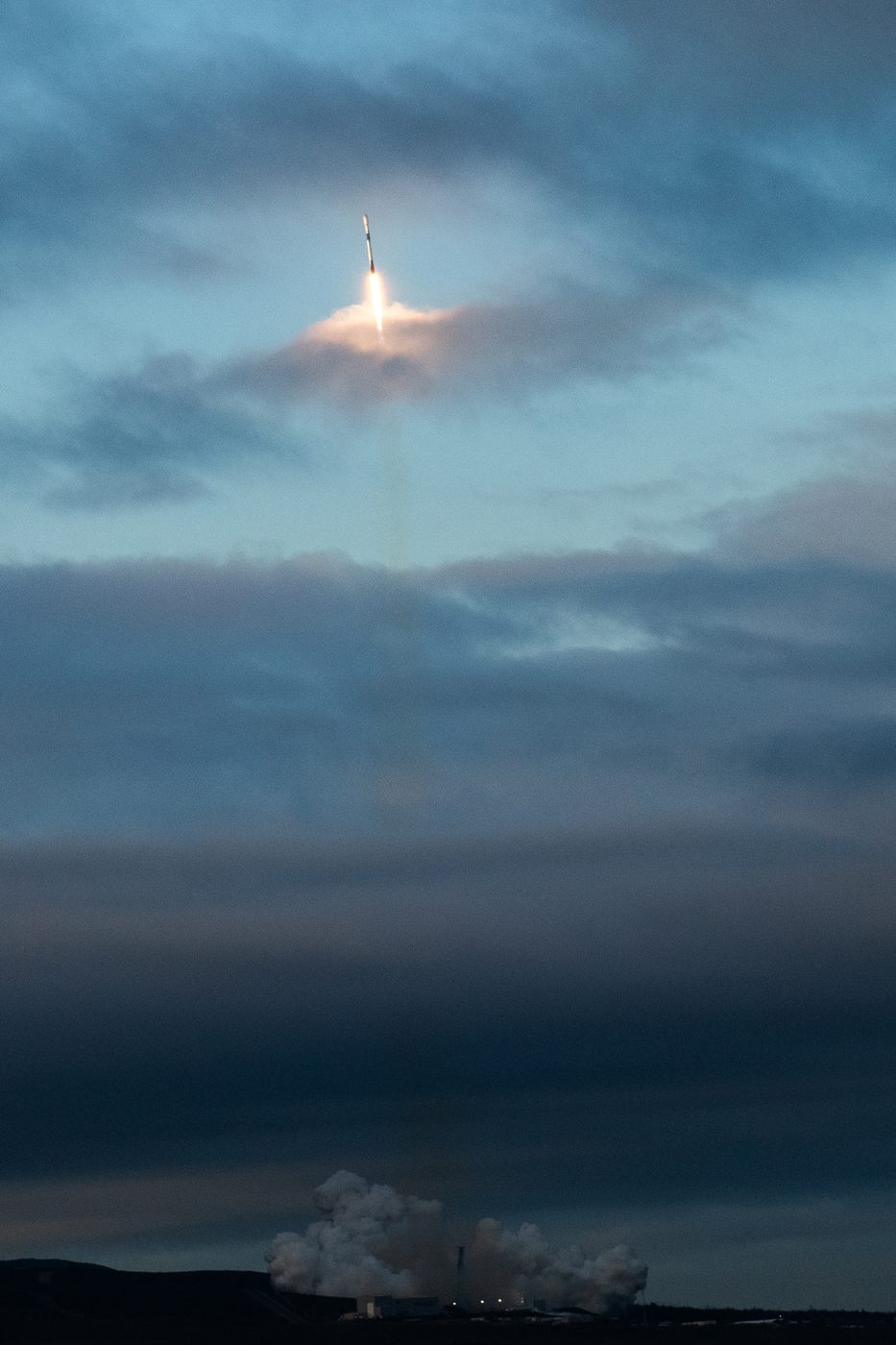A SpaceX Falcon 9 rocket climbs through clouds after launching a Space Development Agency Tranche 1 mission from Vandenberg Space Force Base on Sept. 10, 2025