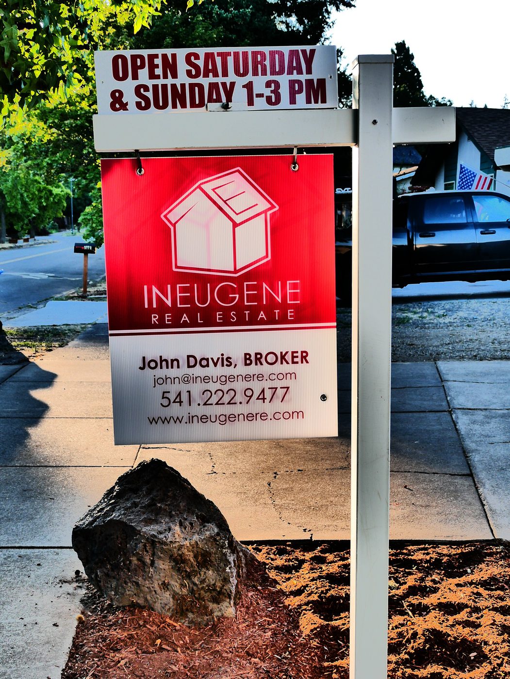 Home for sale and open house signs in front of a house