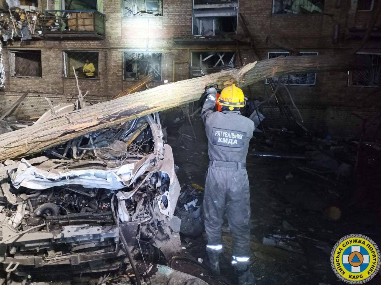 Rescuers work at a destroyed apartment building in Kyiv after a Russian missile and drone attack on April 24, 2025