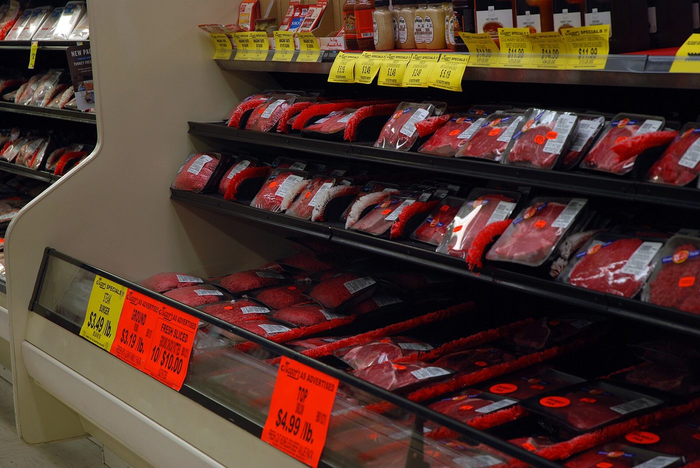 Steaks, ground beef and other cuts of beef in a grocery store cooler