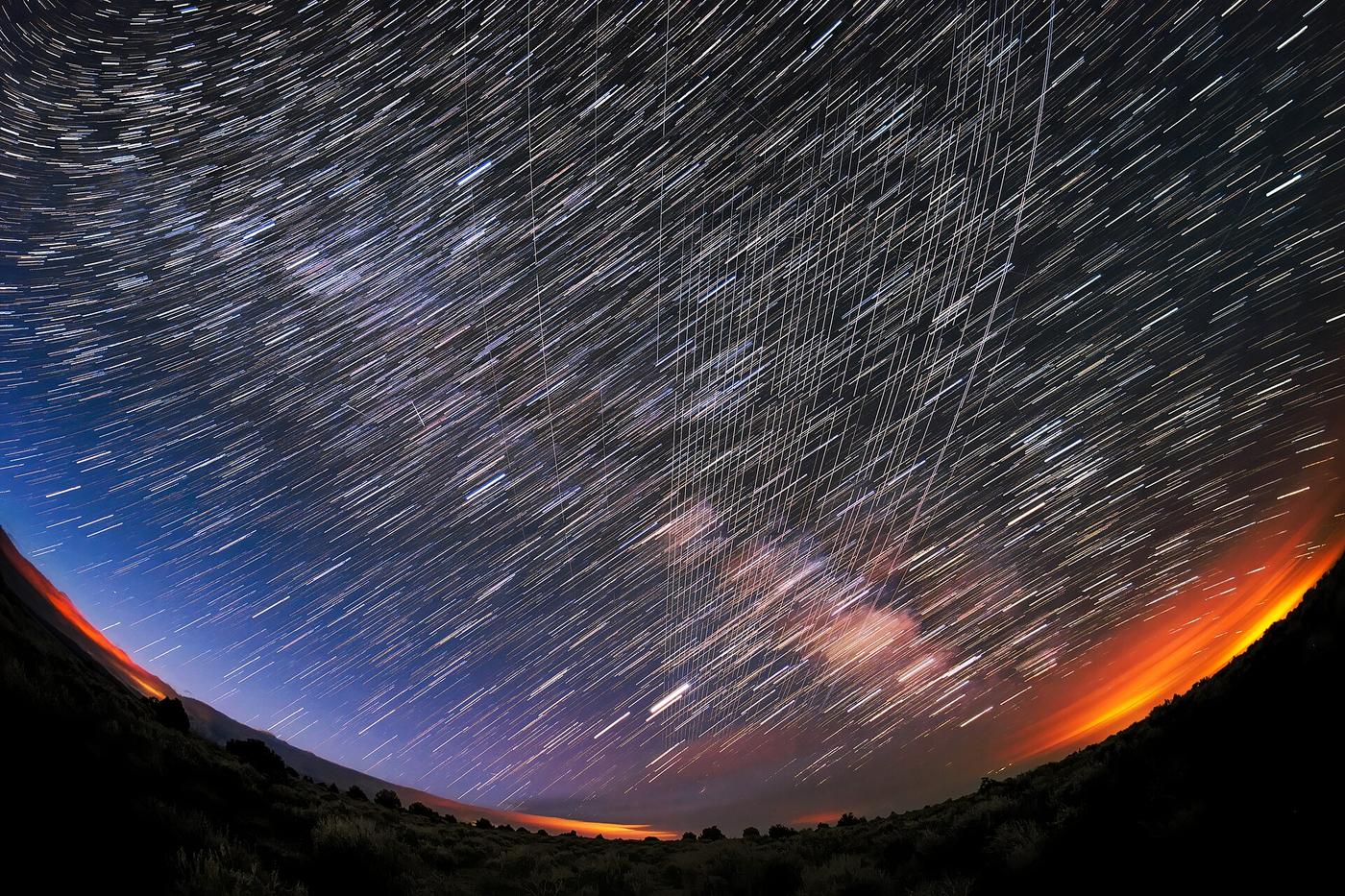 A long-exposure photo of Starlink satellite trails over Carson National Forest, New Mexico