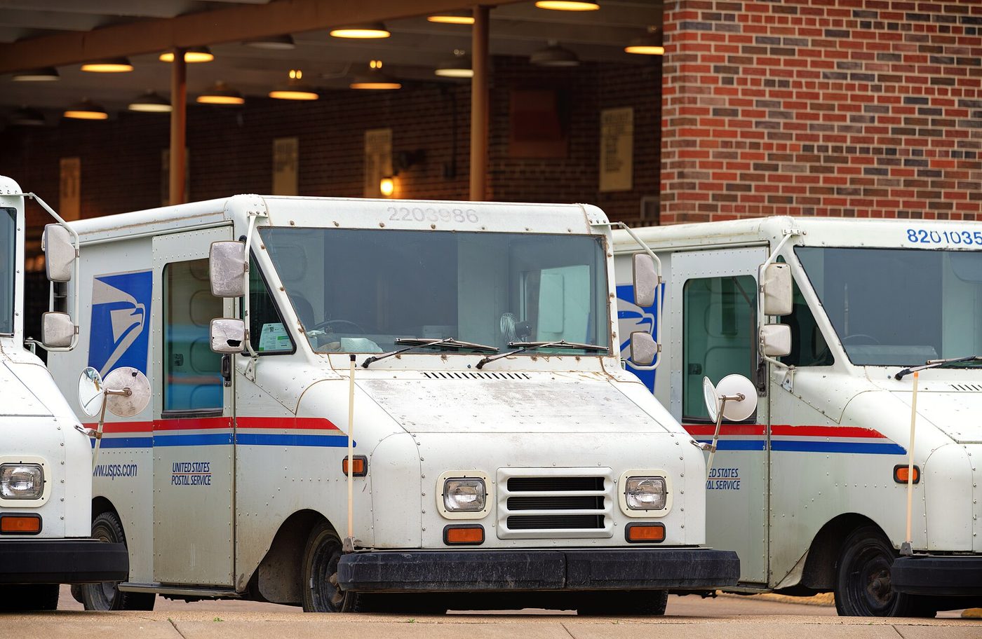 U.S. Postal Service mail trucks outside the post office in Hays, Kansas