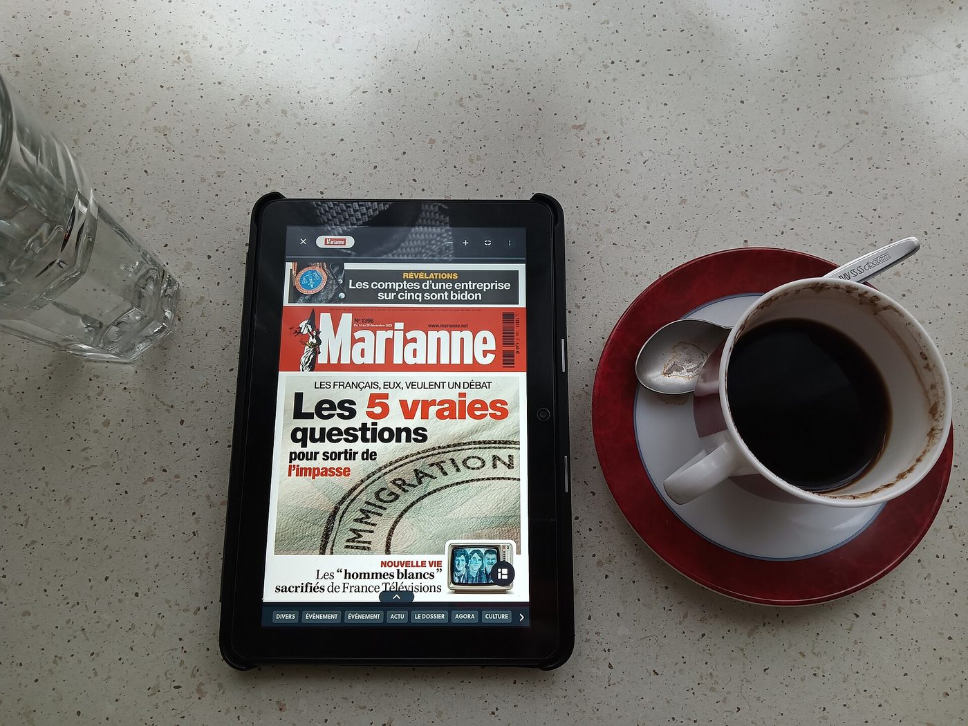 An Amazon Fire HD 8 tablet from 2022 on a table next to a cup of coffee