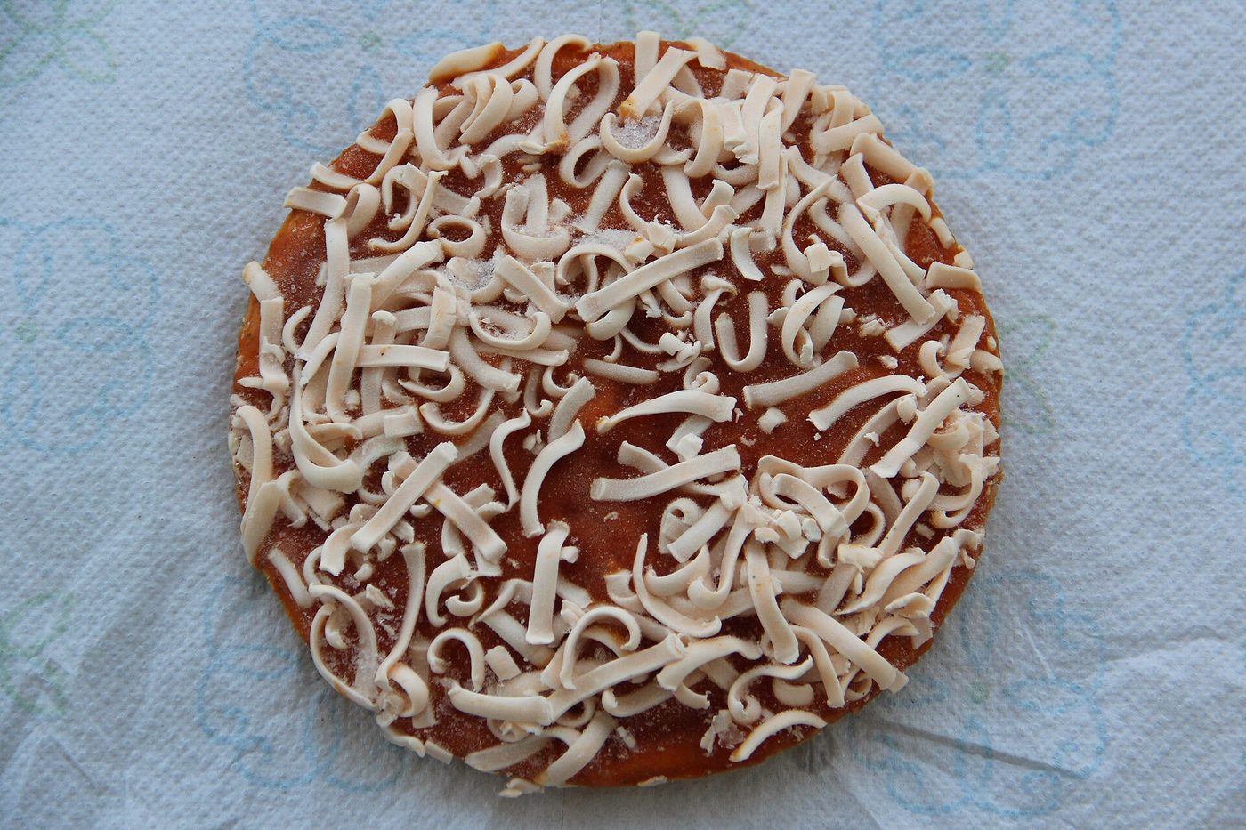 A frozen Celeste Pizza For One out of its box
