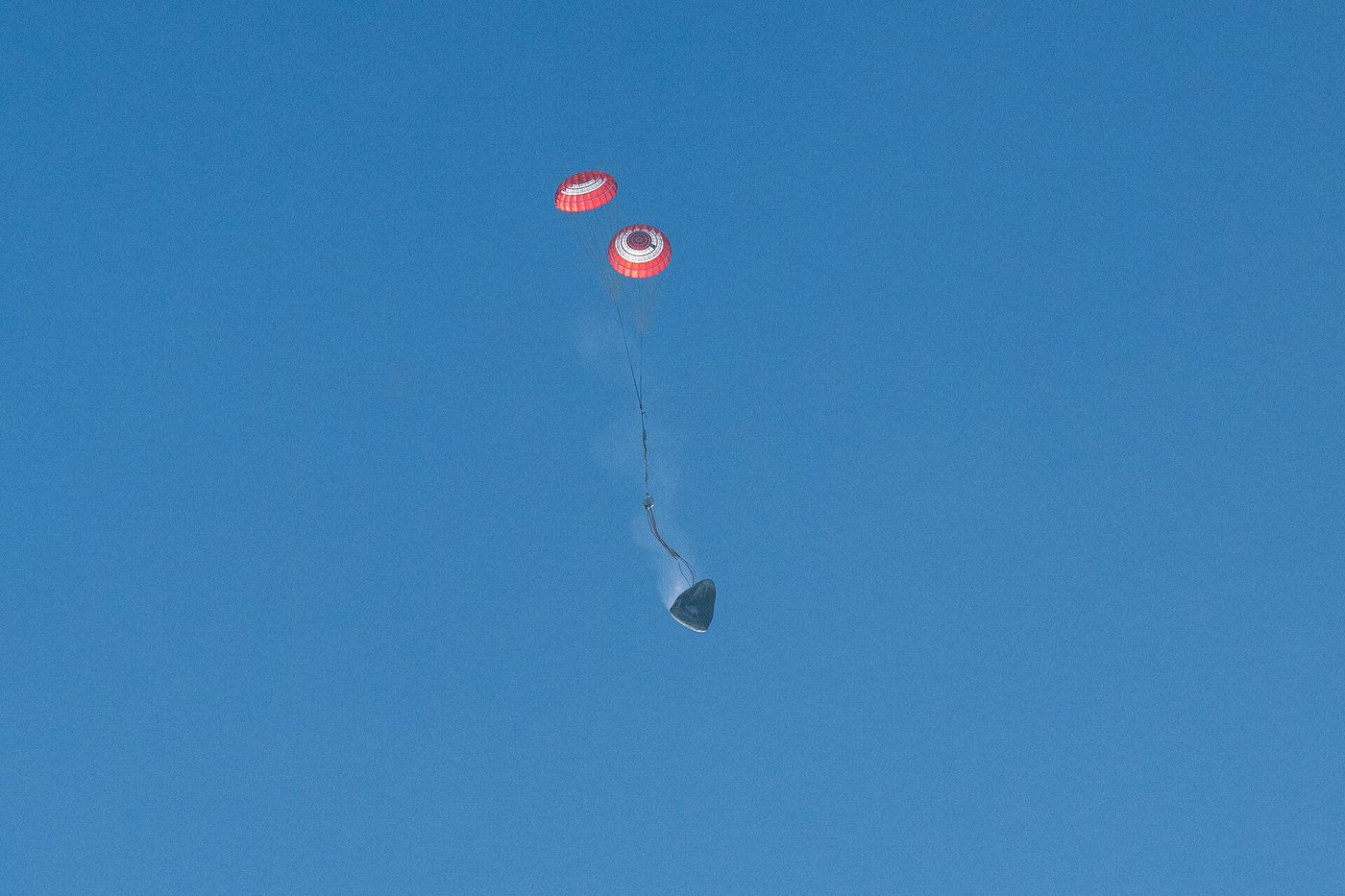 SpaceX's Crew Dragon Freedom descends under parachutes carrying NASA's Crew-12 astronauts on Oct. 8, 2026