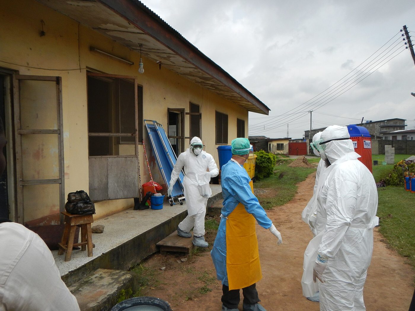 World Health Organization workers put on protective gear before entering an Ebola isolation area