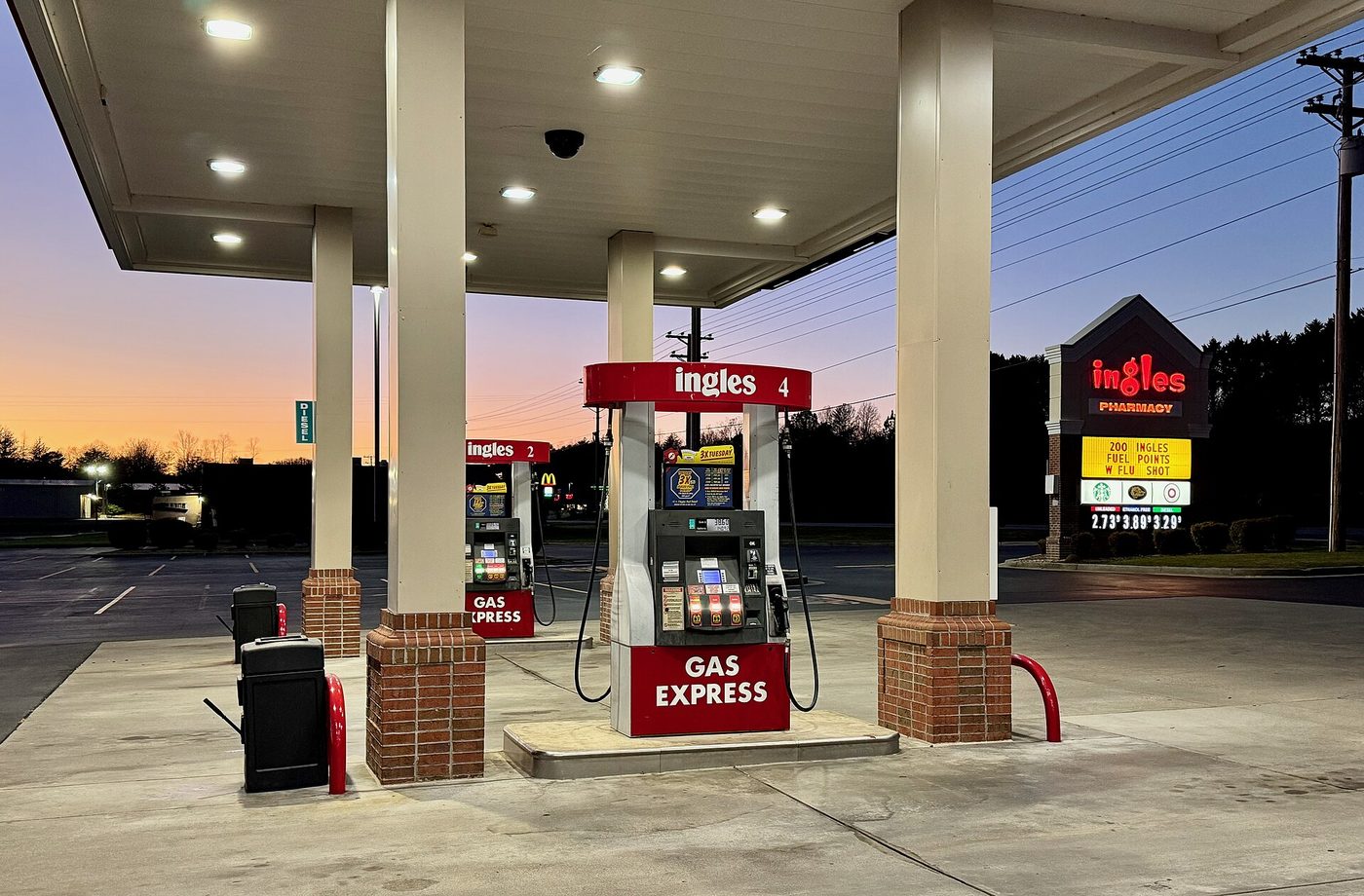 Gas pumps at an Ingles Markets station in Hayesville, North Carolina, at sunset