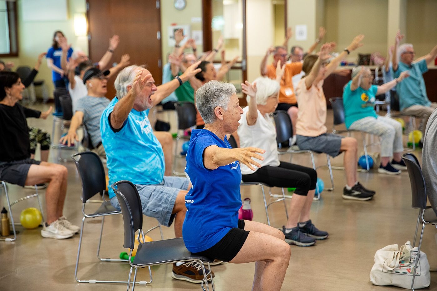 Participants do seated arm exercises in a Power for Parkinson's exercise class