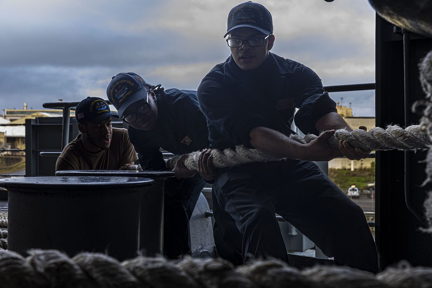 Sailors heave in a line on the fantail of the aircraft carrier USS Abraham Lincoln in San Diego, March 12, 2025