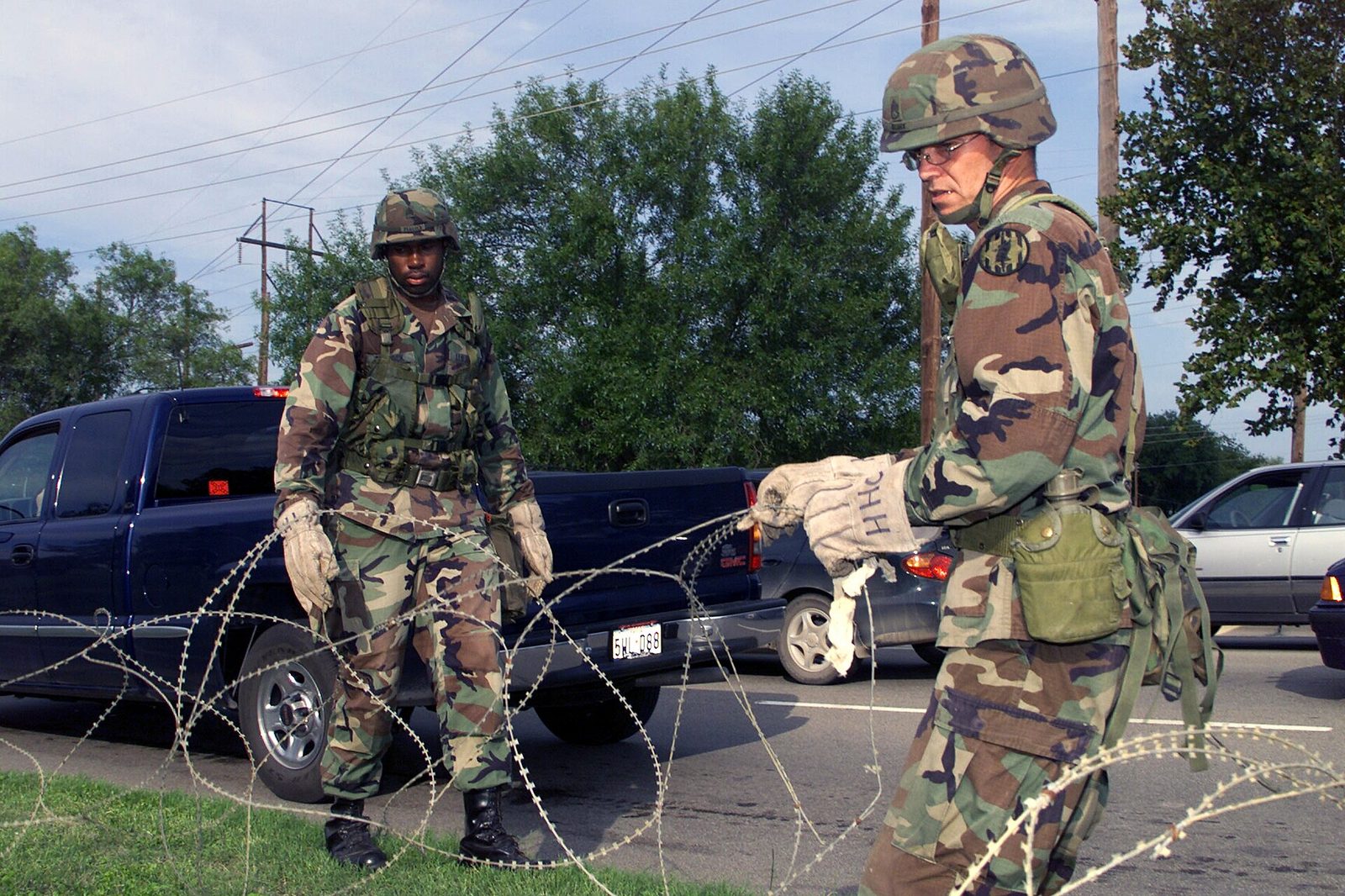 Soldiers place a wire barrier at the main gate of Fort Hood, Texas, in 2001