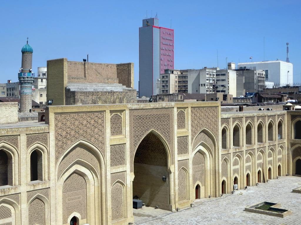 The Central Bank of Iraq tower rises behind historic buildings in Baghdad