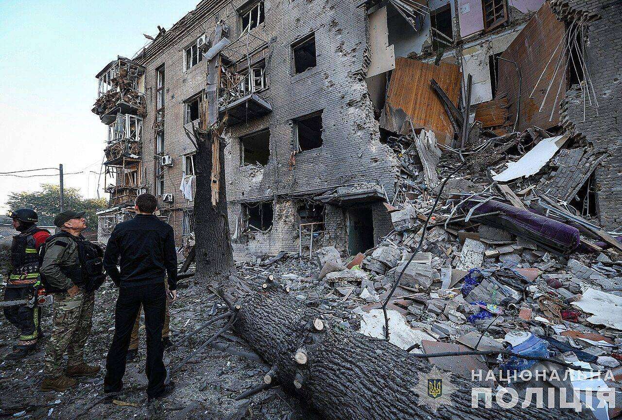 Rescuers stand by a damaged apartment block in Zaporizhzhia after an earlier Russian attack in September 2024
