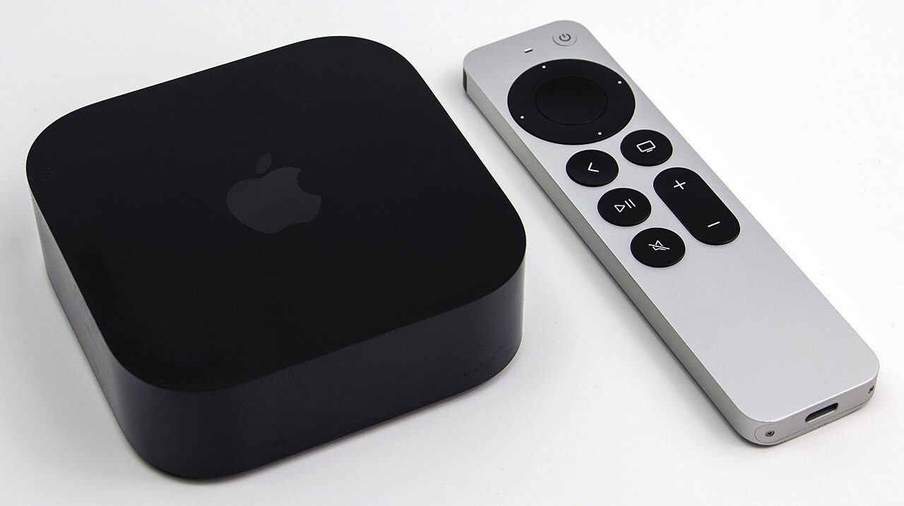 An Apple TV 4K box next to a Siri Remote