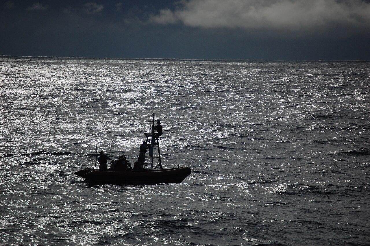 Crew members servicing an ocean monitoring buoy at sea from a NOAA ship