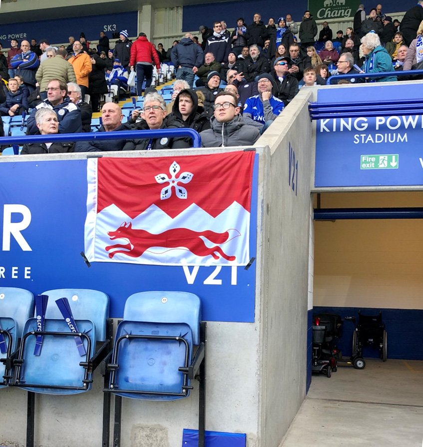 Fans hold up a Leicester flag inside the King Power Stadium