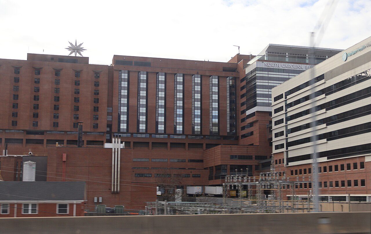 A large hospital building seen from a highway