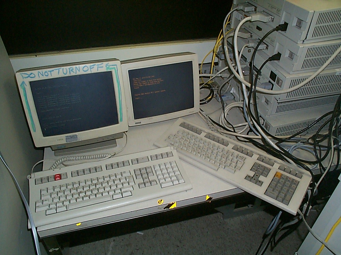 Computer terminals stacked in the corner of a server room