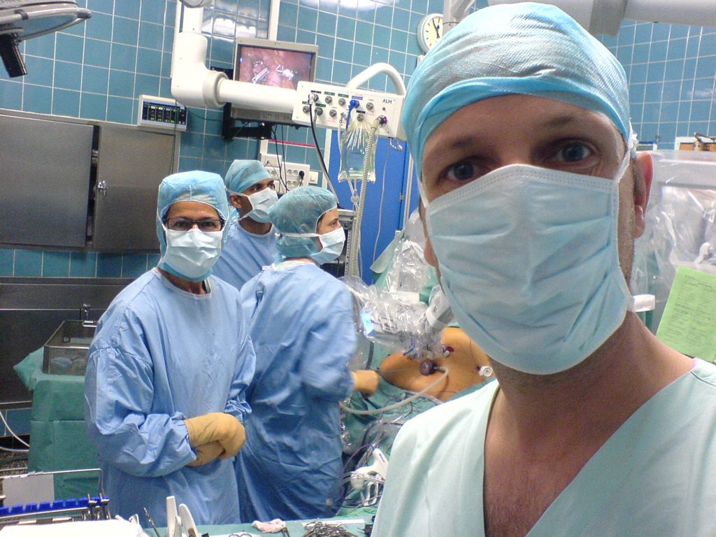 A surgeon seated at the console of a surgical robot