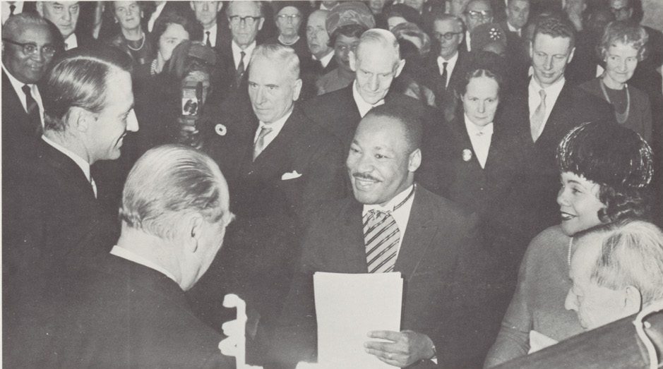 Archival U.S. Information Agency photo of Martin Luther King Jr. being congratulated by King Olav V and Crown Prince Harald of Norway.