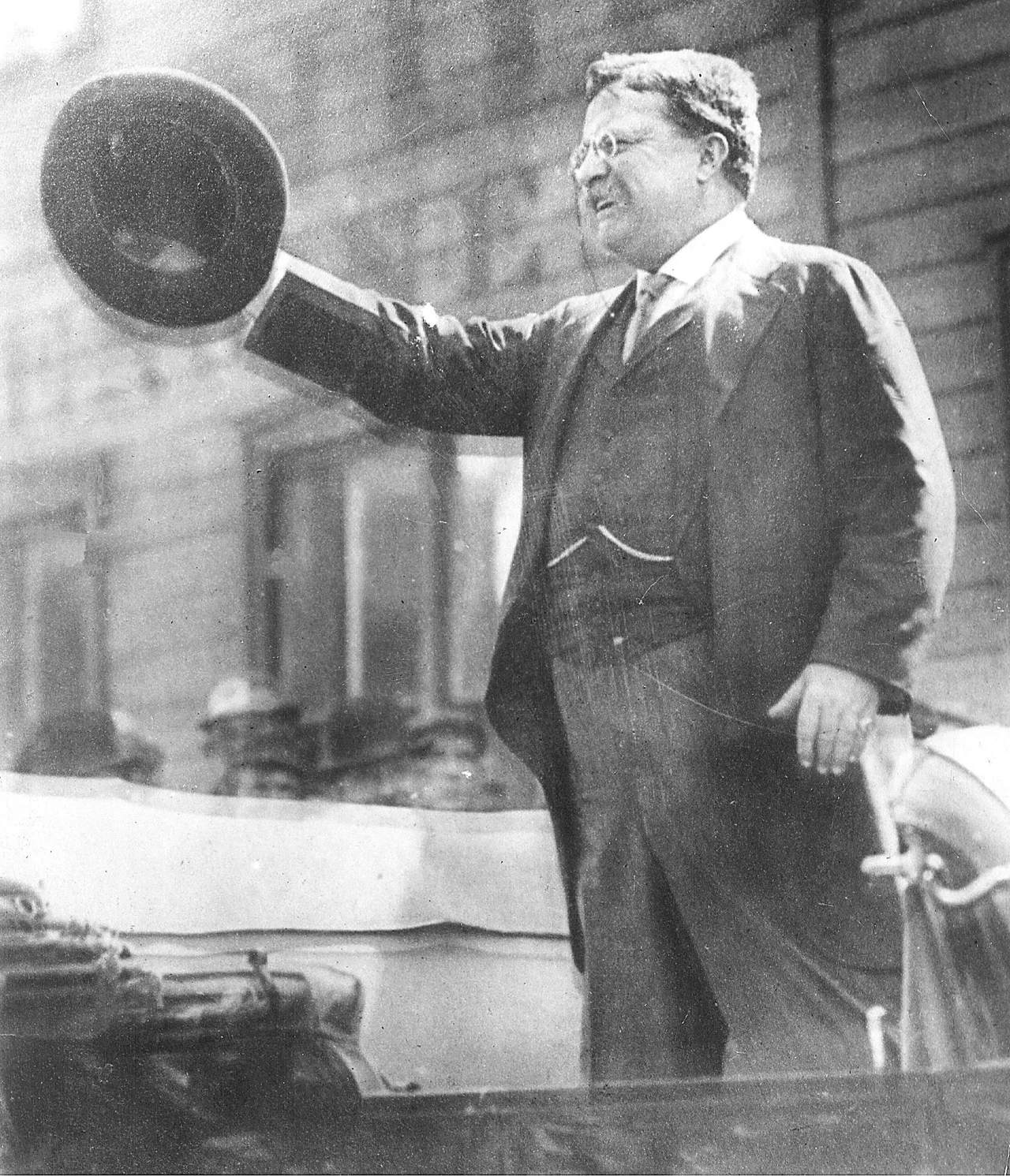 Archival black-and-white photo of Theodore Roosevelt speaking from a car in Milwaukee on October 14, 1912.