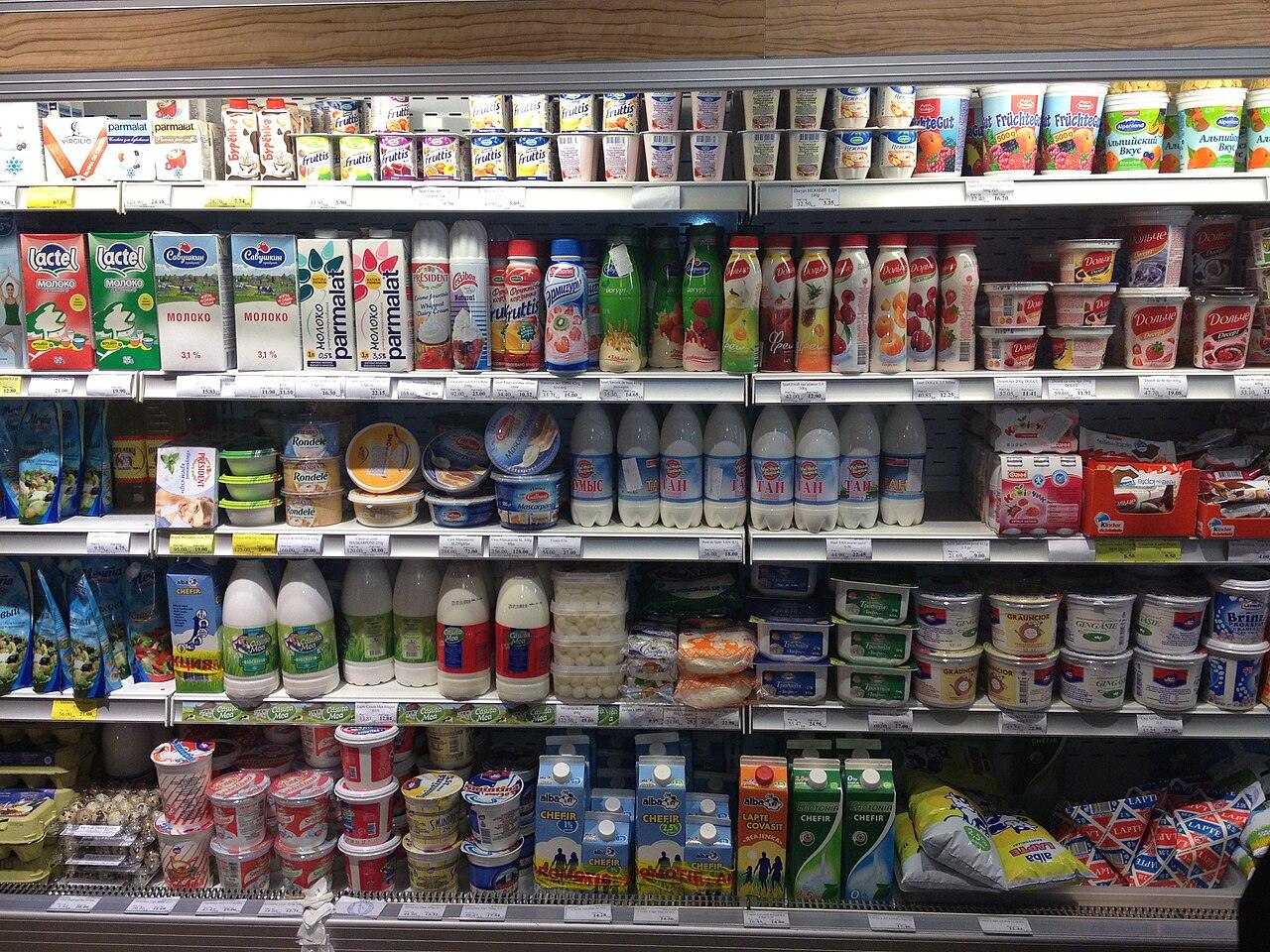 Supermarket shelves stocked with yogurt, dairy drinks and other chilled foods
