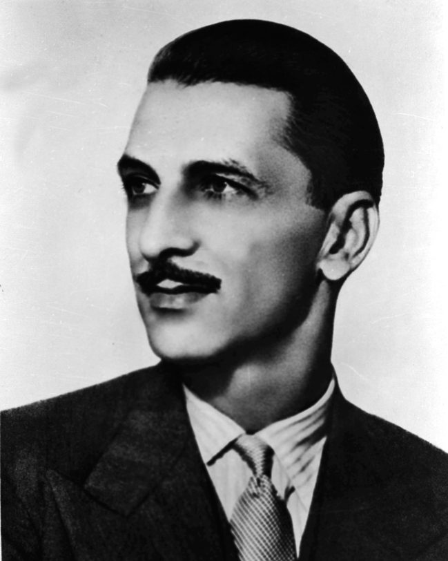 A black-and-white portrait of JRD Tata in a suit and tie