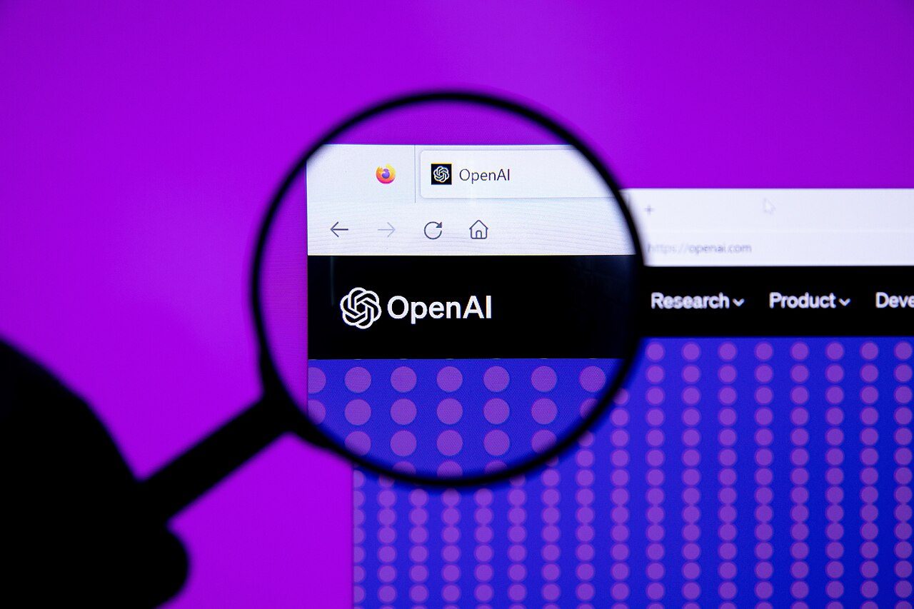 A magnifying glass enlarges the OpenAI logo on a web browser screen against a purple background