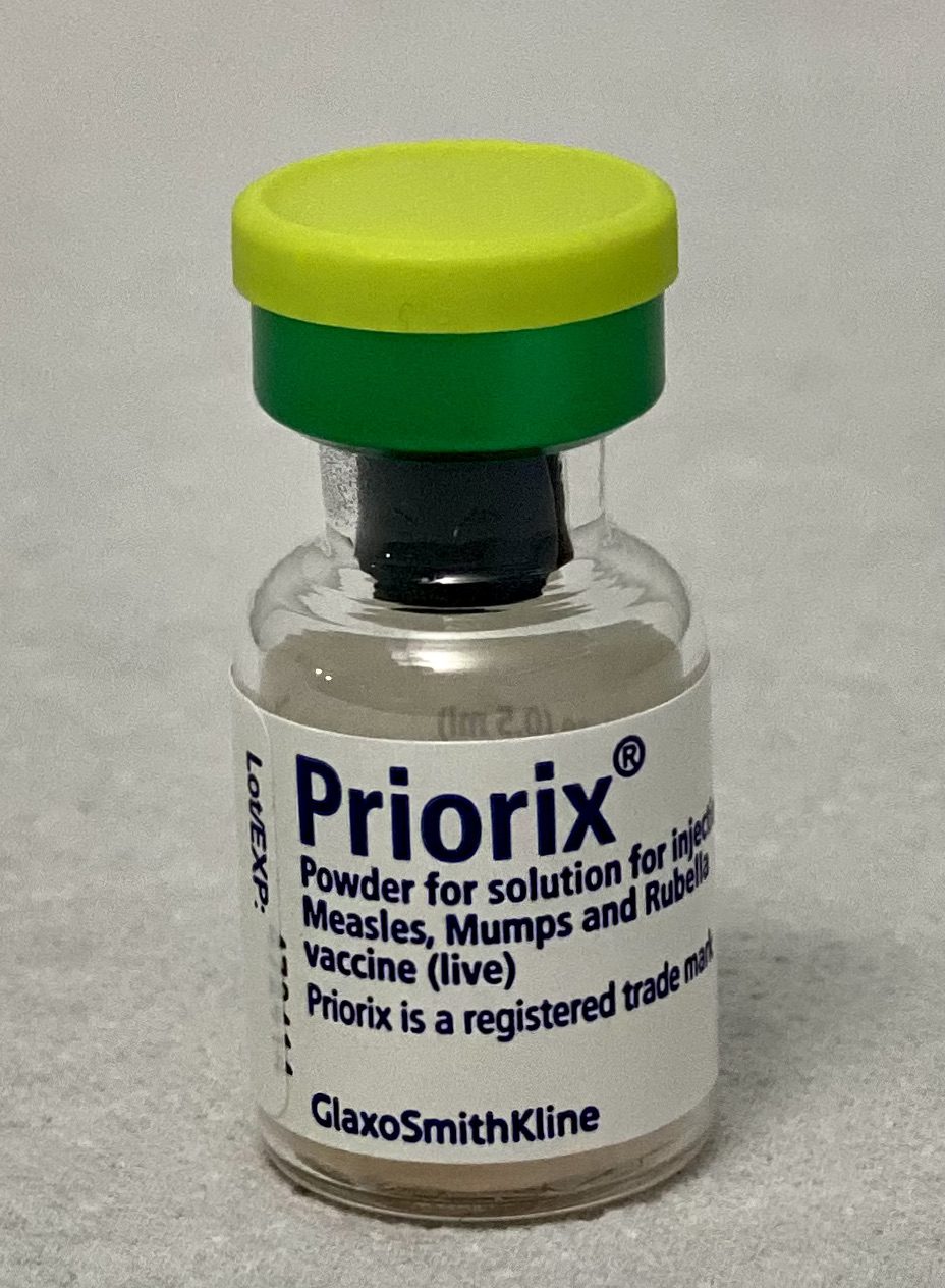 A small glass vial of Priorix measles, mumps and rubella vaccine with a green and yellow cap