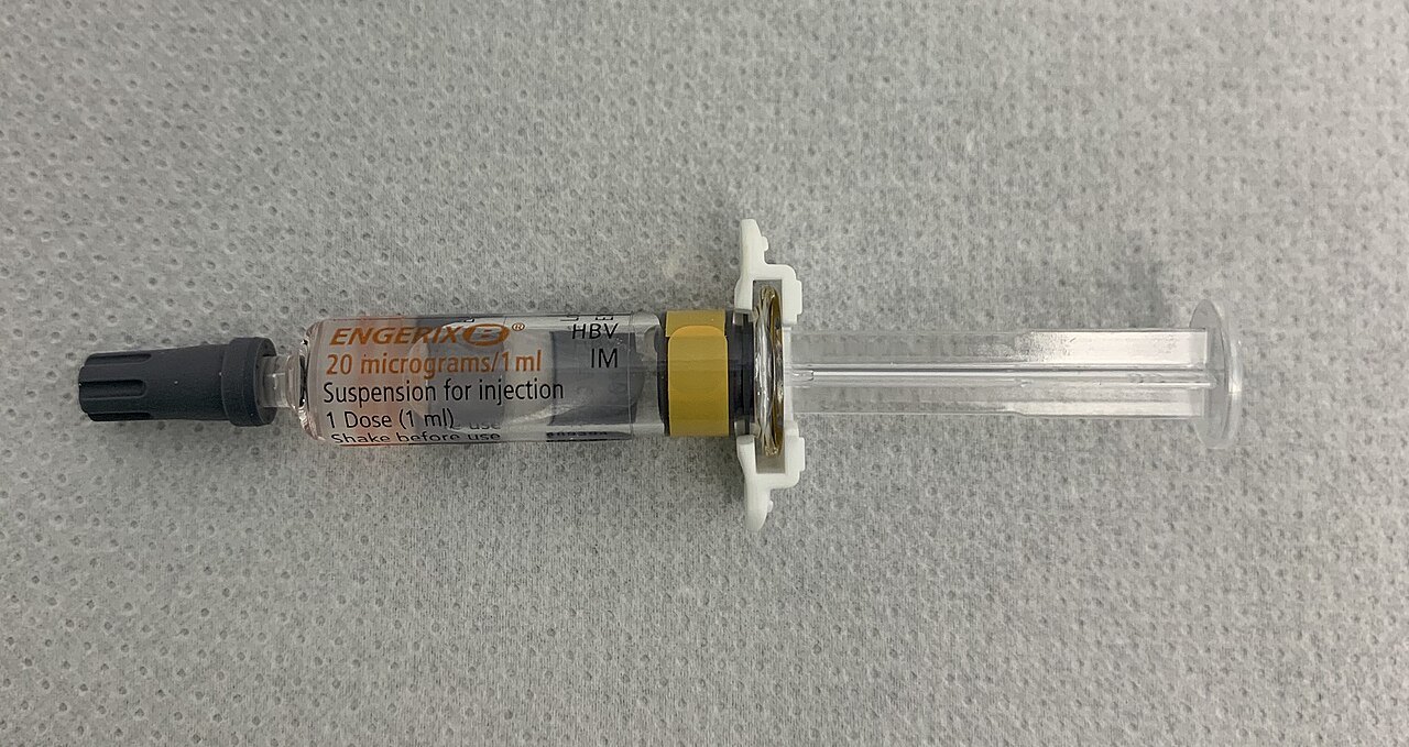 A pre-filled syringe of Engerix B hepatitis B vaccine lying on a gray surface