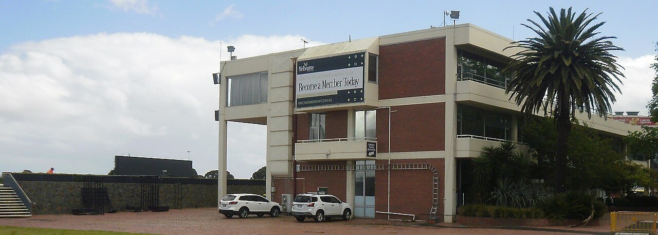 A wide view of buildings and a car park at Caulfield Racecourse in Melbourne on a sunny day