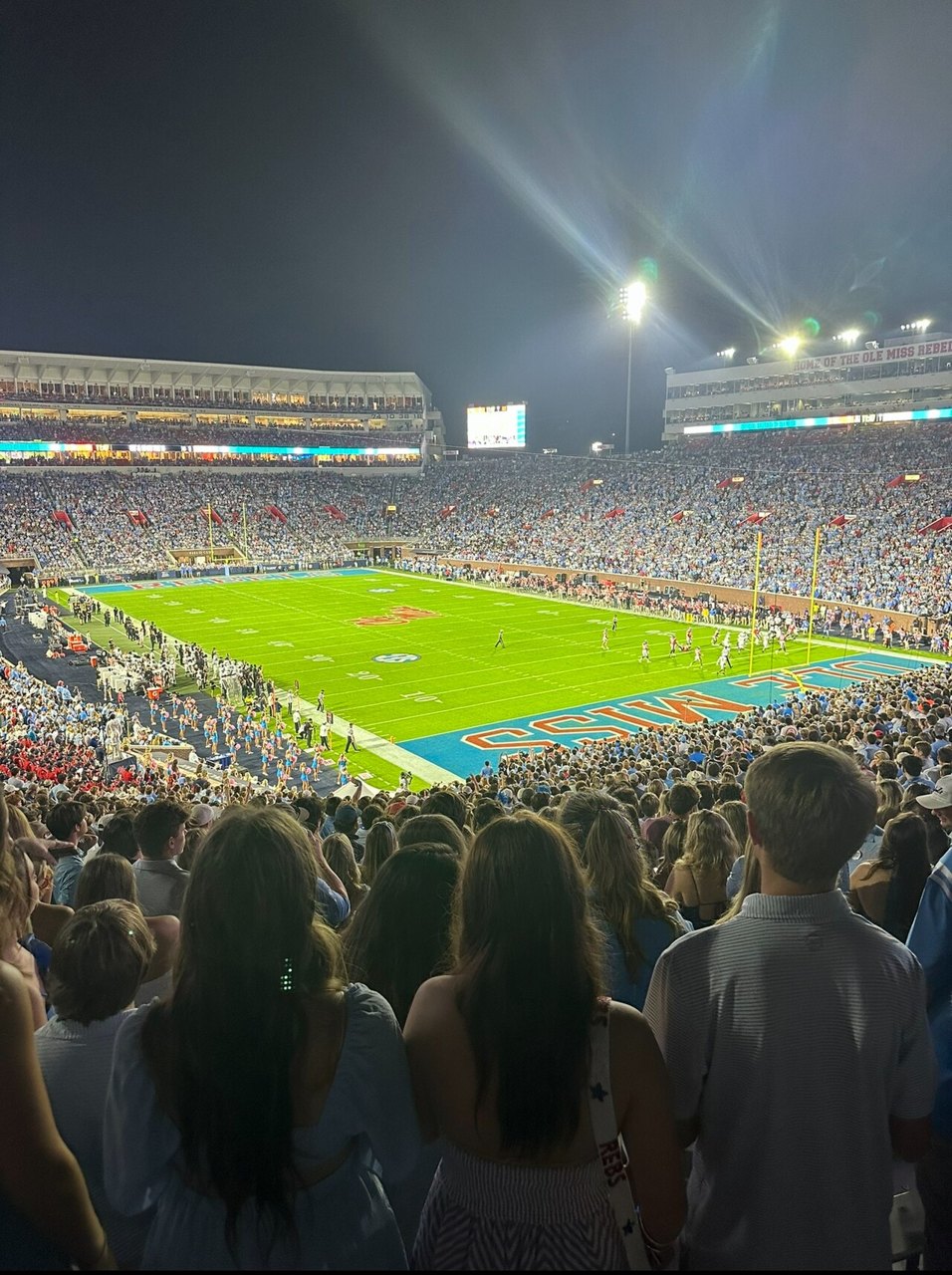 A packed Vaught-Hemingway Stadium at night, with the stands full of fans and the lit field below