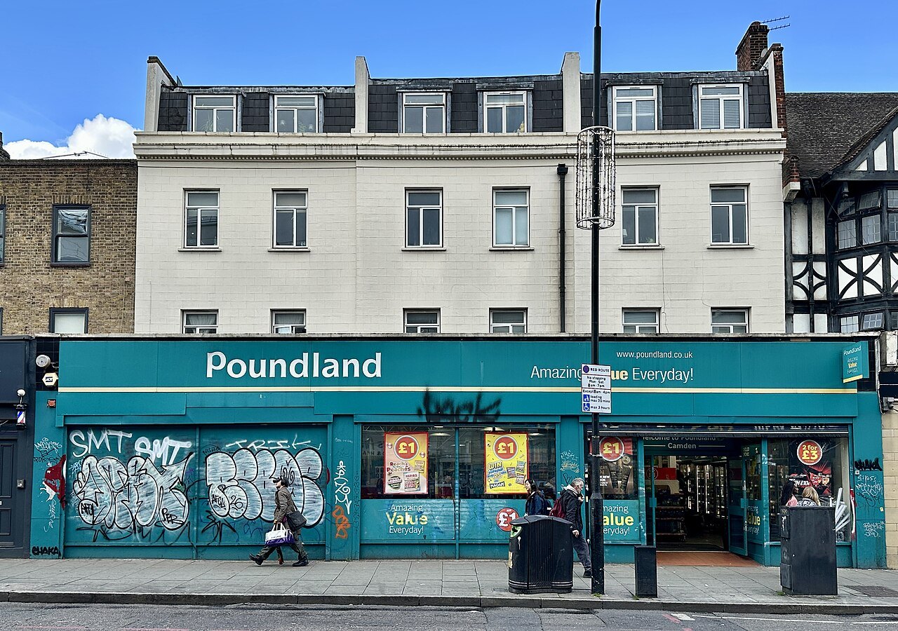 A Poundland shop front with a teal sign on a street corner in London