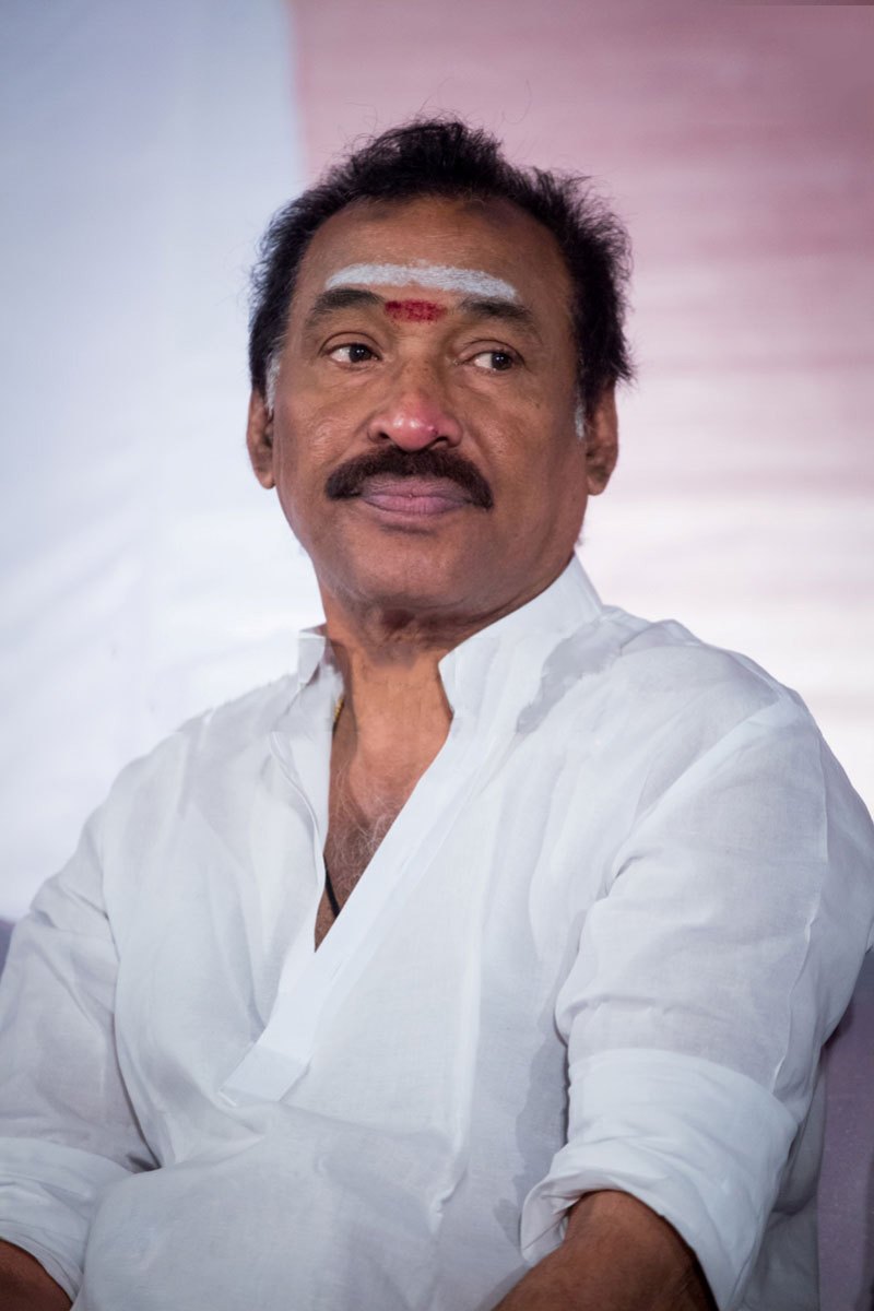 Music director Deva in a white shirt, with a tilak on his forehead, at a press event