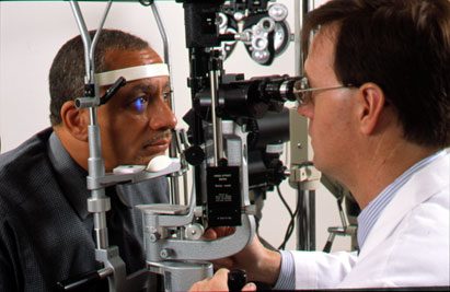 Patient seated at a slit-lamp during an eye examination in a clinic