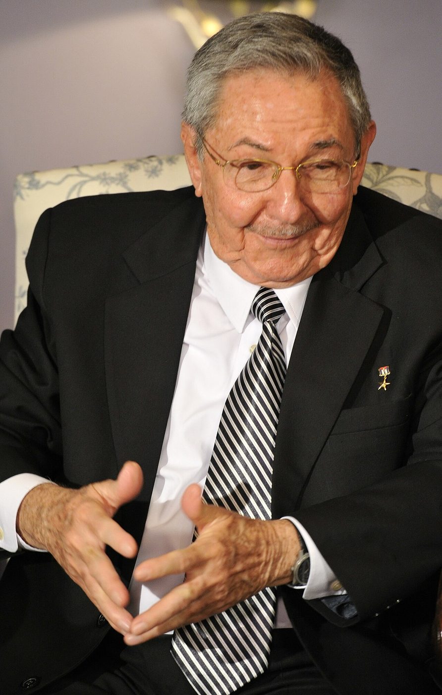 Raúl Castro in a dark suit seated at a formal meeting in July 2012