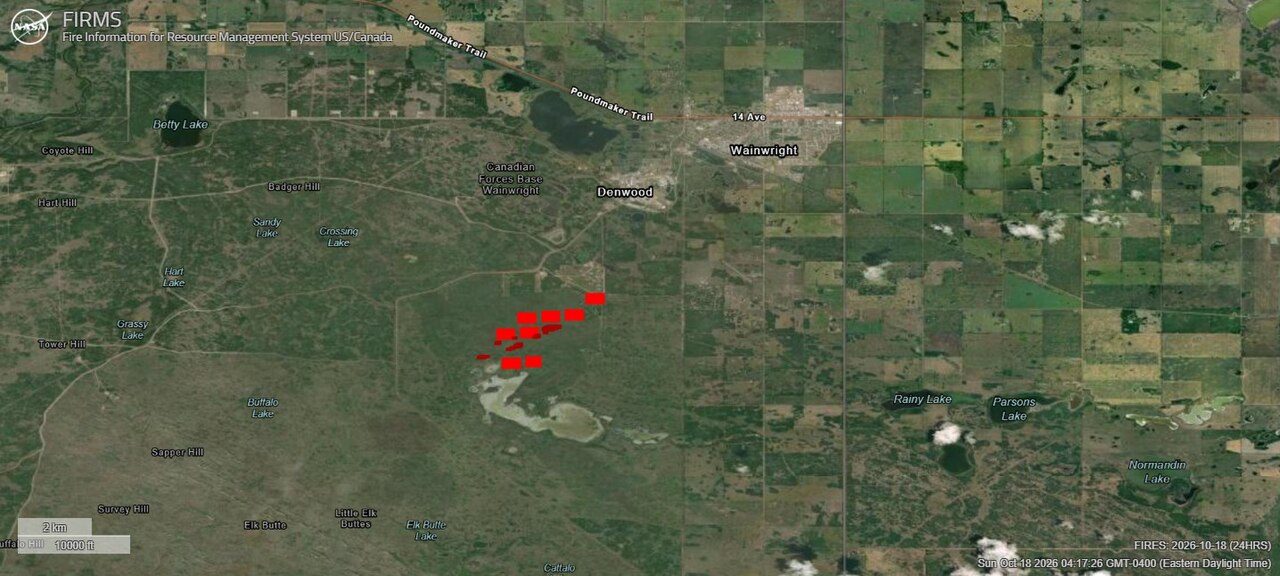 A satellite map of flat Alberta farmland and grassland with a cluster of red fire markers south of the town of Wainwright