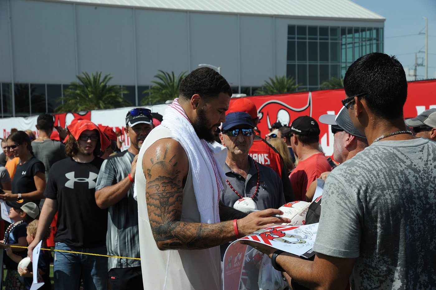 Mike Evans signing autographs for fans at a training camp
