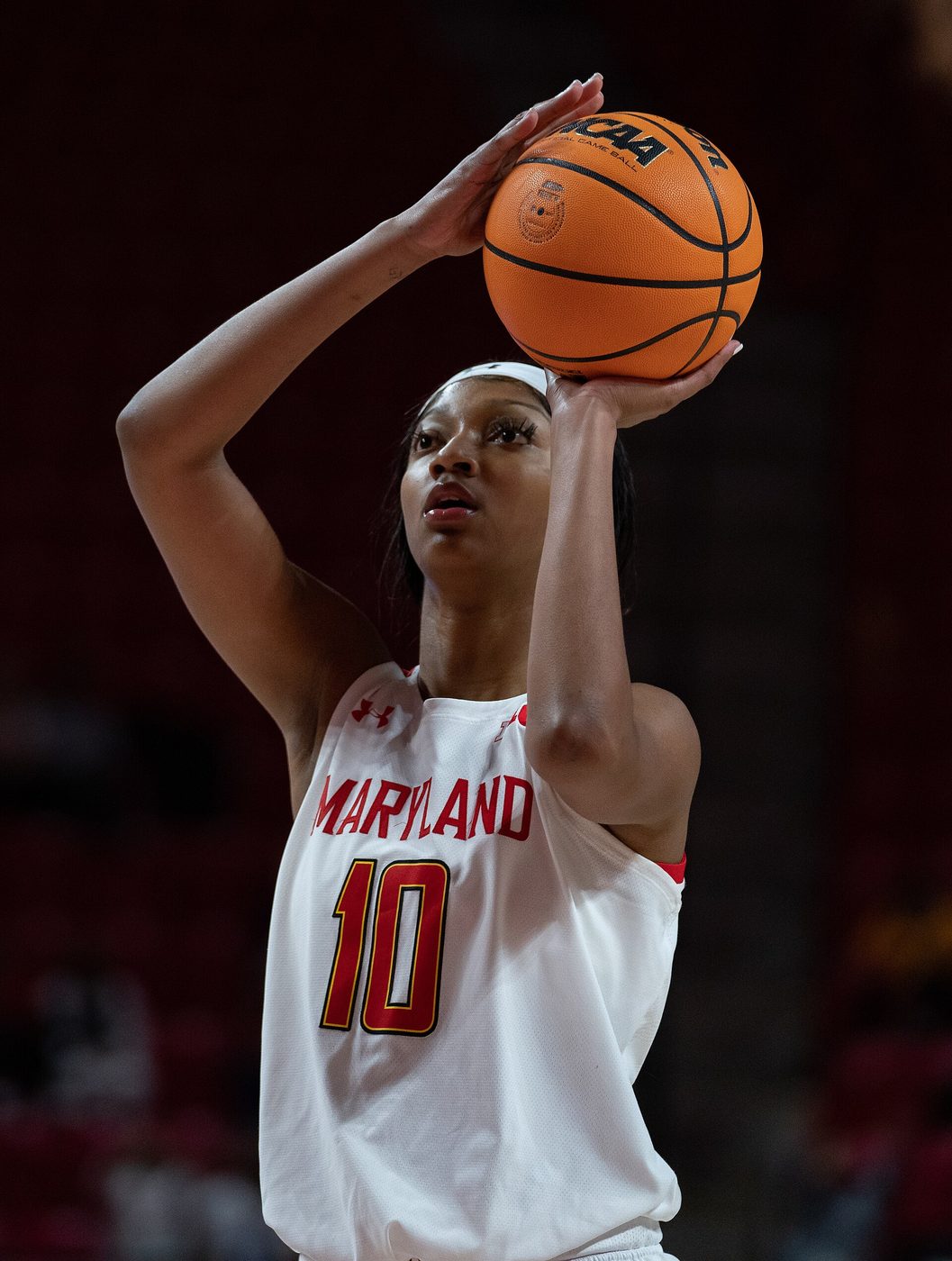 Basketball player Angel Reese in a college uniform on the court