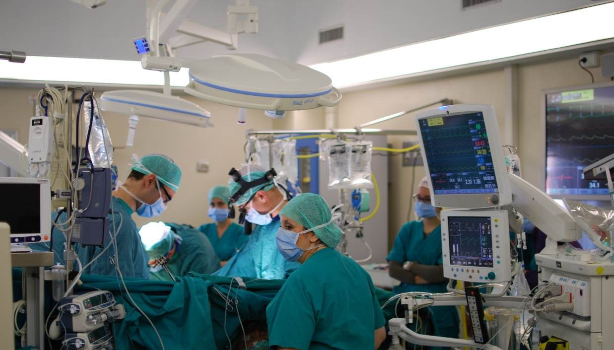 Surgeons operating in a cardiac surgery room