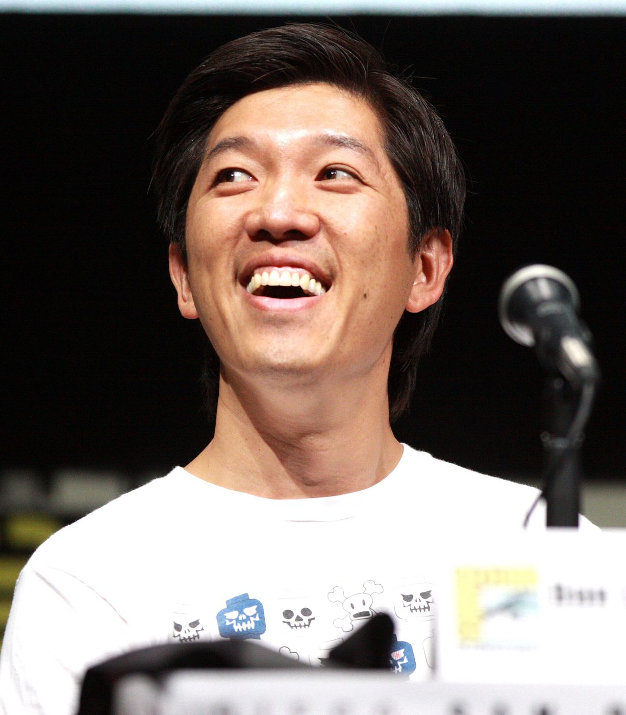 Film producer Dan Lin smiling at a panel at San Diego Comic-Con