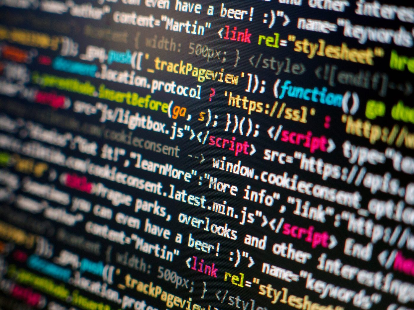 Computer screen showing lines of colorful HTML and JavaScript source code